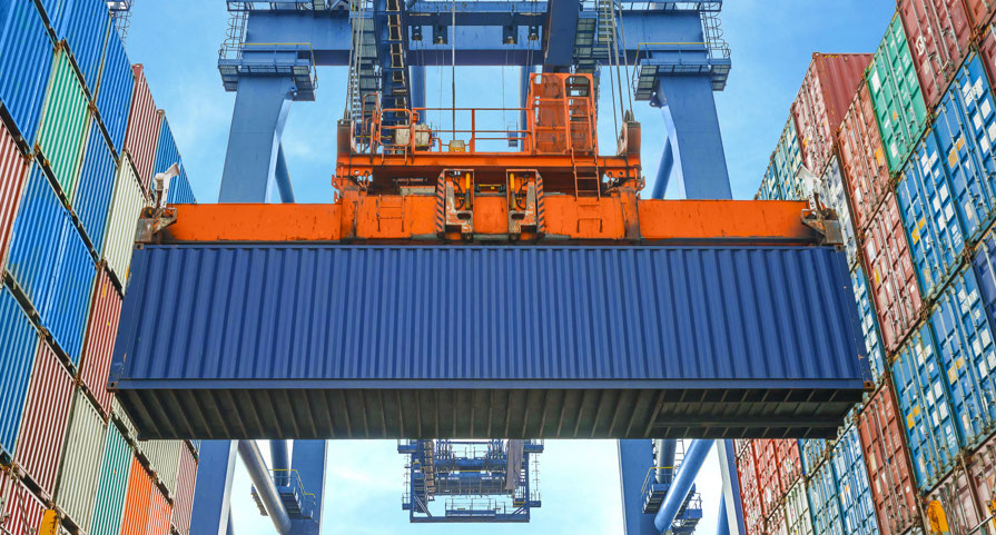A cran carrying a shipping container