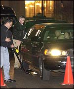 A security guard checks cars