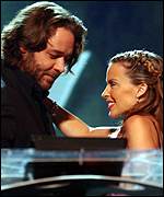 Russell Crowe greets Kylie Minogue