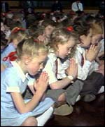 Children praying for the victims of the 1989 Hillsborough football tragedy