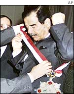 Iraqi President Saddam Hussein receives a Kurdish honour