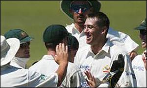 Glenn McGrath celebrates with his team-mates after the wicket of Graeme Smith 
