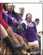 Miniskirted demonstrators protest a day ahead of the summit