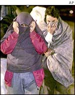 Men leave the Sangatte refugee centre hoping to get through the Channel Tunnel