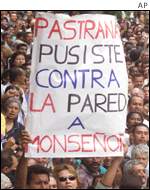 Mourner at funeral with sign saying 