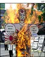 An effigy of Japanese Prime Minister Junichiro Koizumi is burned during an anti-Japan rally, Seoul, May 2001 