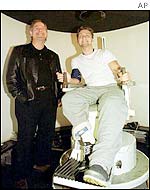 Lance Bass (right) talks with Jim McDonald of RadioShack during the tests in Russia