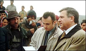 Mr Funar (right) talks to gypsies at the rubbish dump