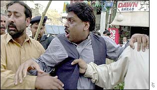 Plainclothes policemen arrest political activist