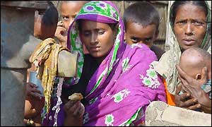 Women and children wait for water