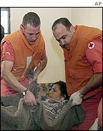 Lebanese Red Cross workers try to help injured Lebanese woman 