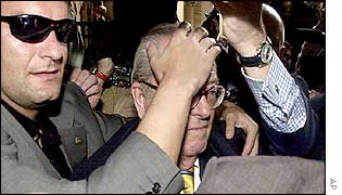 Far-right leader Jean-Marie Le Pen is pelted with eggs as he hands in his papers