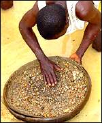 A man looks for diamonds in a river