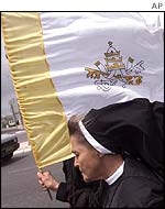 A nun carrying the Vatican flag