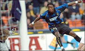 Mohammed Kallon of Sierra Leone shoots at Feyenoord's goalie Edwin Zoetebier 