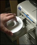 CD being put into a hard drive 