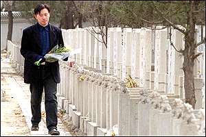 A man visits a grave at Beijing's Babaoshan cemetery