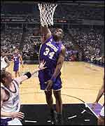 Shaquille O'Neal slam-dunks a basket for the LA Lakers