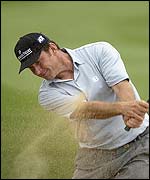 Nick Faldo plays out of the sand