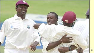 West Indies fast bowler Pedro Collins hugs Wavell Hinds after the dismissal of Wasim Jaffer of India 