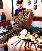 Police show weapons they say were recovered in the raid