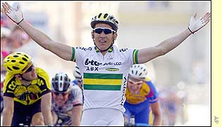 Australian Robbie McEwen extends his arms as he crosses the finish line
