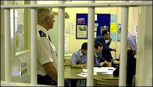 Prison officer conducts a lesson behind bars