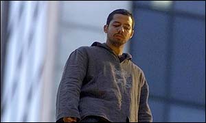 David Blaine looking down from atop pillar