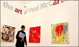 Critic looking at McCartney paintings
