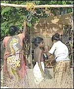 Refugee girls draw water at a camp