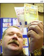 Man holds up euro notes