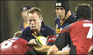 Pat Howard attacks for the Brumbies but is thwarted by the Crusaders tacklers