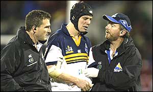 Stephen Larkham of the ACT Brumbies leaves the field early in the match