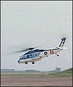 A helicopter takes off to look for signs of the plane