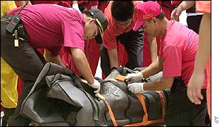 Rescuers secure the body of a victim