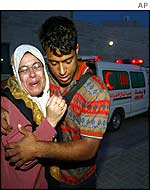 Palestinians grieve after the bodies of a Palestinian woman and her daughter arrive at hospital 