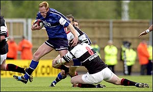 Peter Anglesea is tackled by his opposite number Michael Owen