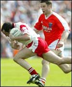 Brian Dooher (with ball) and Paul McGrane in action