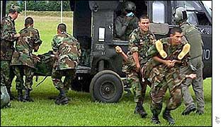 Soldiers carry body of leftist rebel from helicopter on Sunday