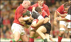 Ben Evans of Wales (left) tackles Josh Kronfeld