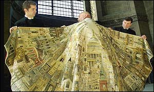 Vergers Michael Page (left) and Dr John Seymour adjust the Jubilee Cape