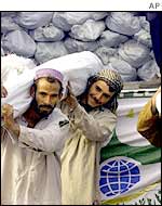 Afghans distribute aid at a UNHCR facility