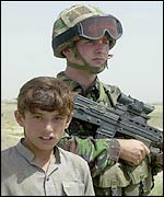A member of Operation Buzzard and an Afghan boy
