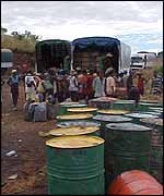 Fuel drums for the black market being loaded onto trucks