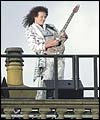 Brian May of Queen plays God Save the Queen on the roof of Buckingham Palace