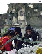 Youngsters search the rubble for their belongings after a raid on the Rafah refugee camp