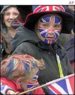 Children wait for the Queen's procession