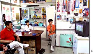Car body shop workers watch the match 