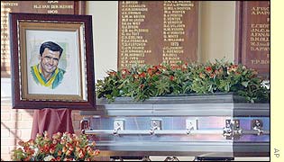 A hand-drawn image of Cronje stands next to his coffin