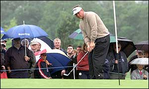 Darren Clarke chips onto the green at the eighth